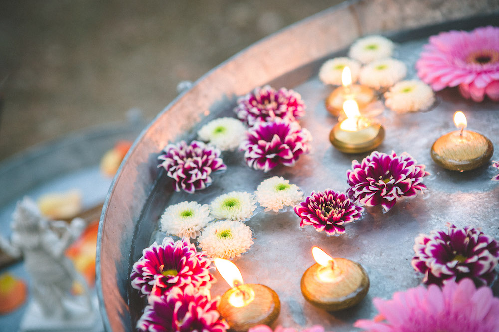 Flowers in water décor at an interfaith wedding ceremony
