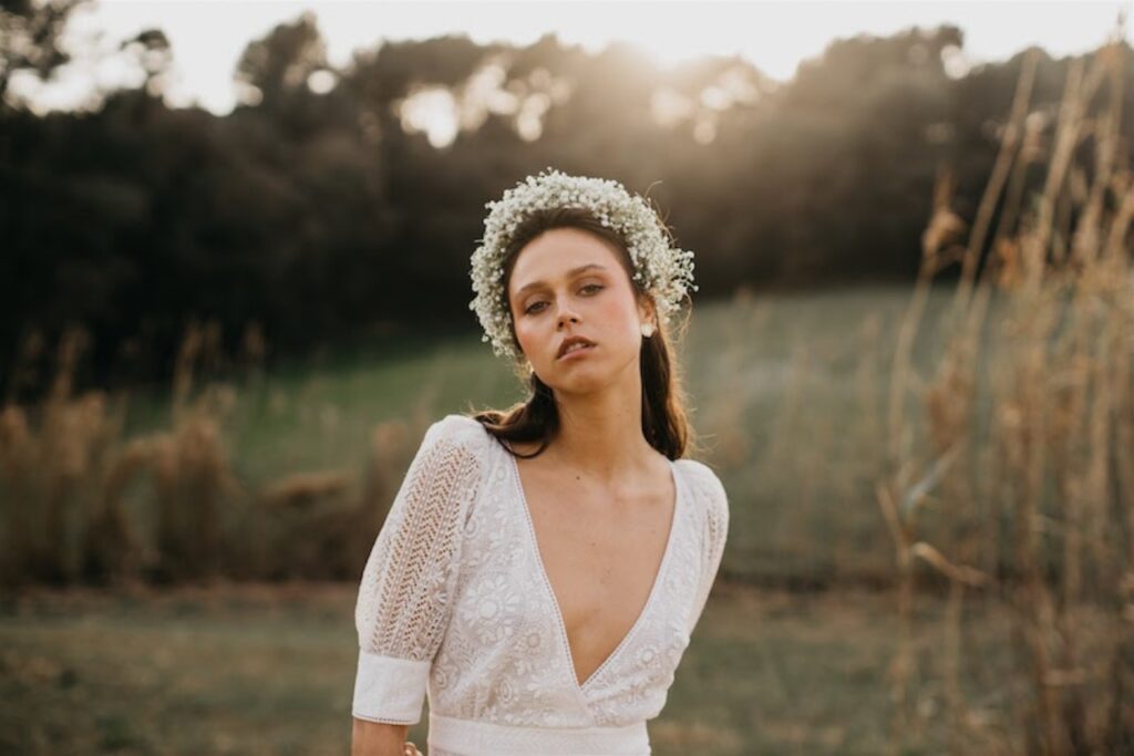 A bride in a field wearing a floral headband