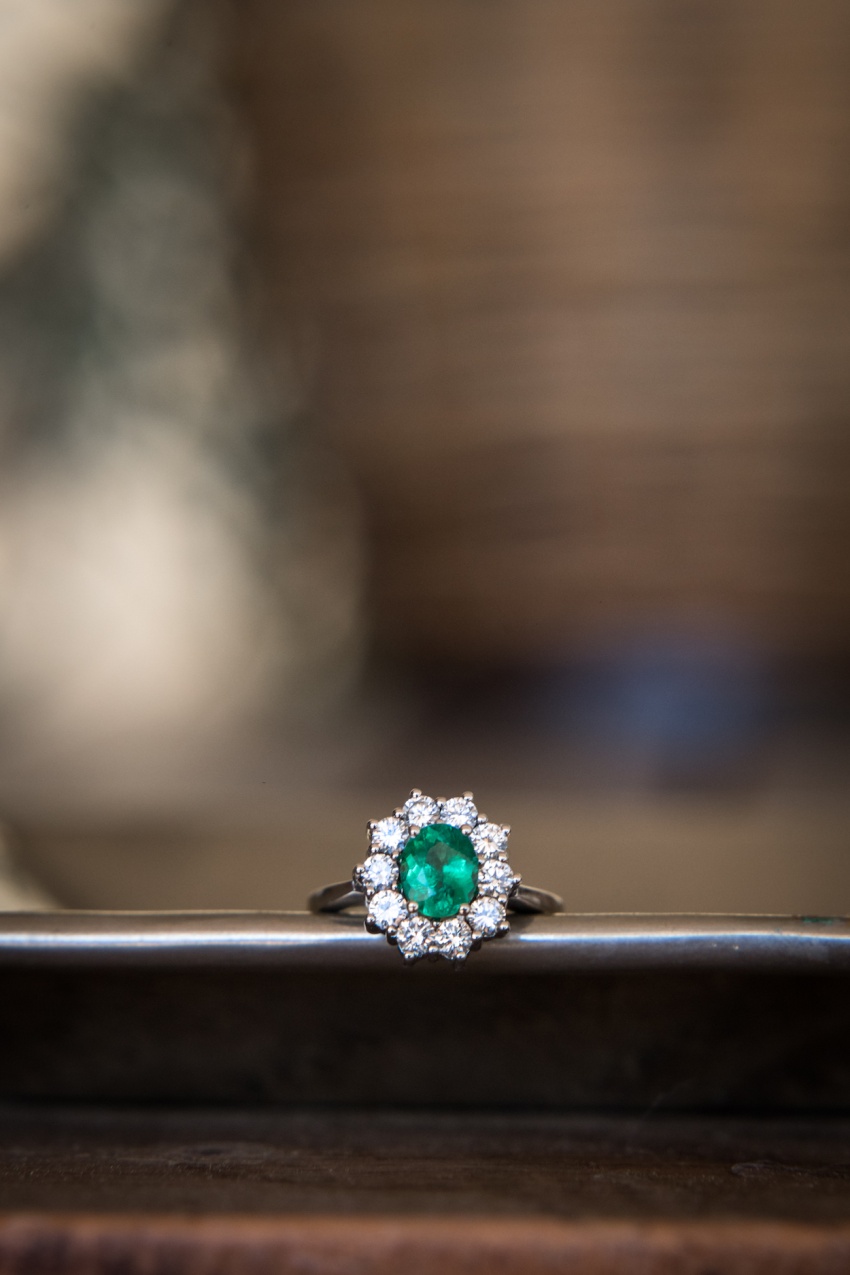 An emerald and diamond engagement ring