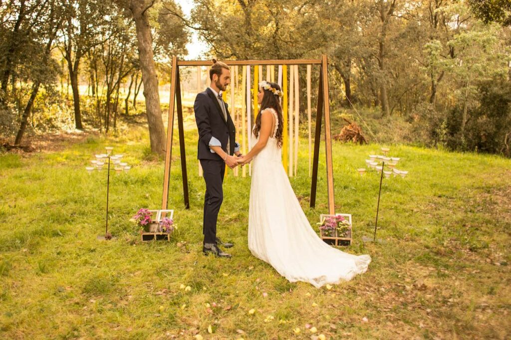 A bride and groom holding hands and saying their wedding vows