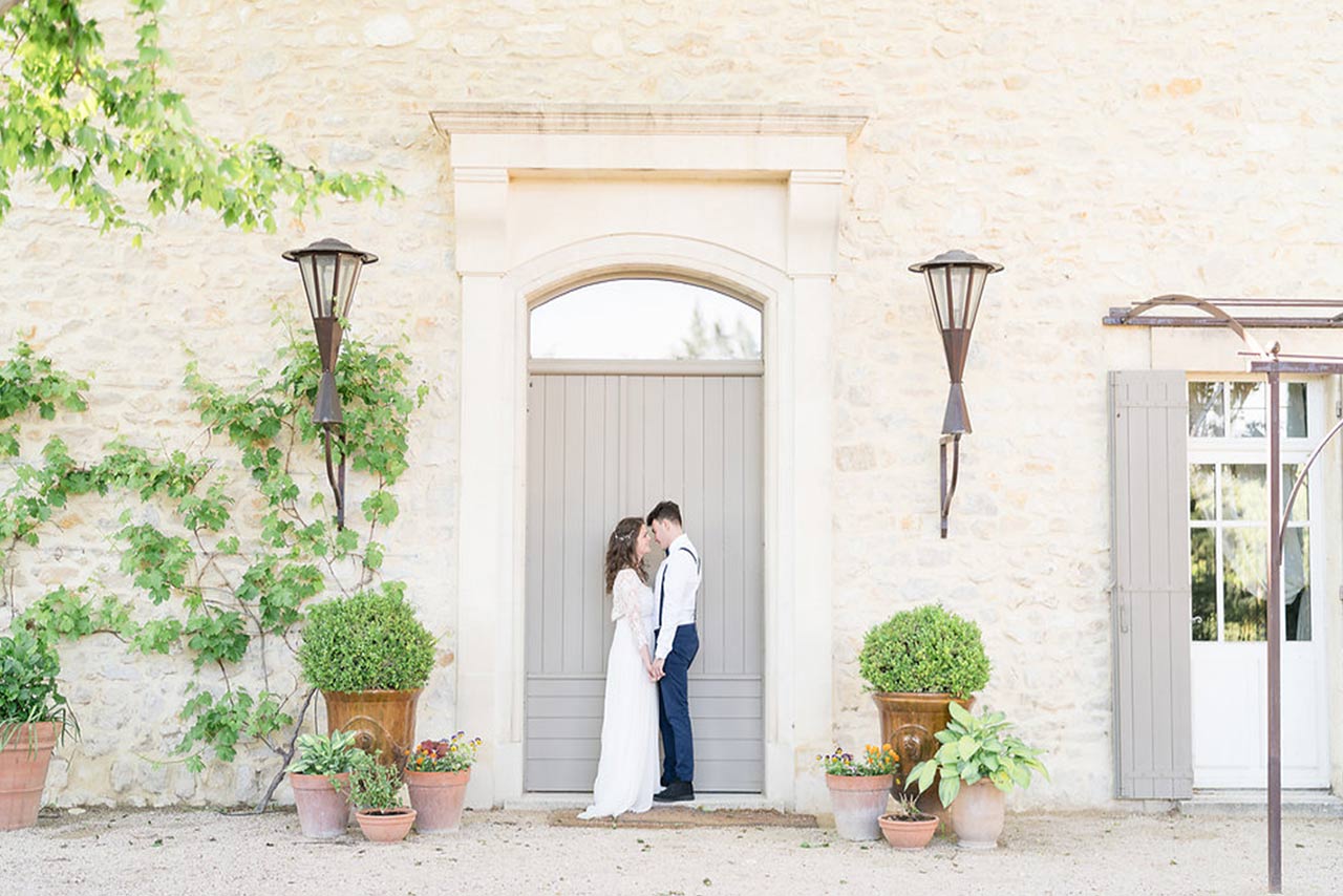 A couple on their wedding day stood in front of a door