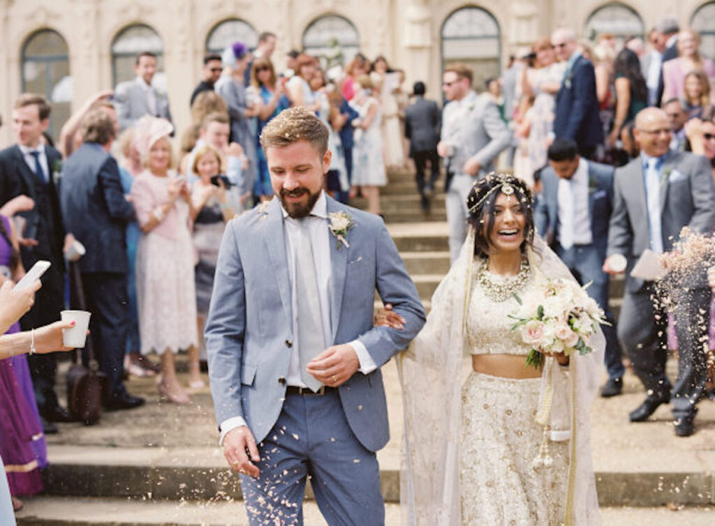 A bride and groom walking outside at an interfaith wedding