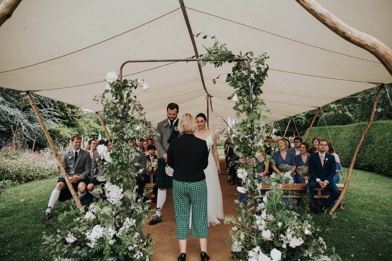 A wedding tent with green foliage