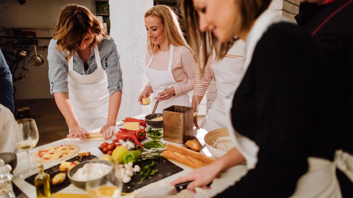 A group of women gathered at a private cooking class for a hen party in Barcelona